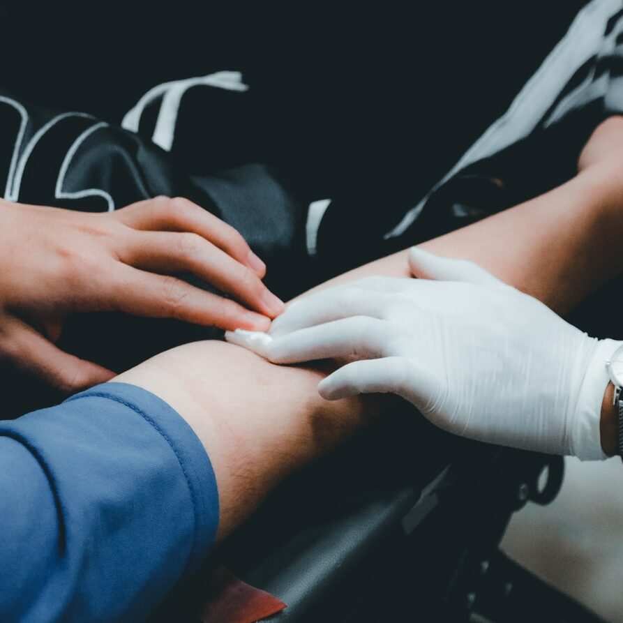 person in blue long sleeve shirt holding persons hand