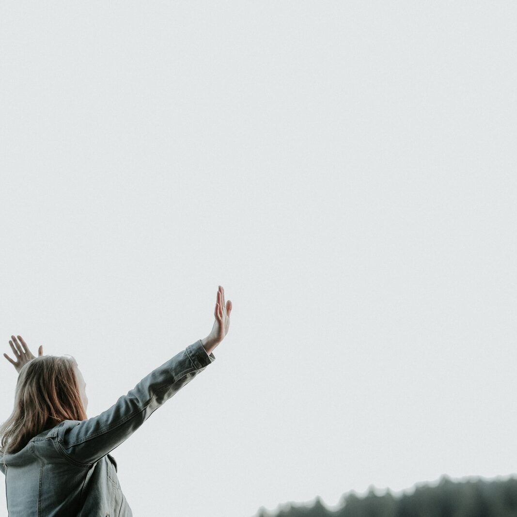 woman raising her hands